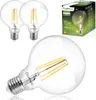 A product shot of three LED light bulbs, with one in the foreground and two in the background, next to a product box. Produktbild-Vorschau