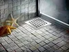 A shower drain in a tiled bathroom. Produktbild-Vorschau