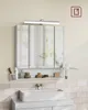 A modern bathroom vanity with a mirrored cabinet, shelf, and sink, illuminated by a light bar. Náhled obrázku produktu