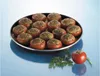 A dish of stuffed tomatoes is presented on a blue surface, with a single tomato and parsley sprig in the foreground. Anteprima dell’immagine prodotto