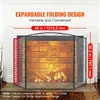 A black metal fireplace screen in front of a brick fireplace. Voir les images du produit