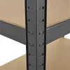 A close-up view of the corner of a black metal shelving unit with light brown particle board shelves. Podgląd zdjęcia produktu