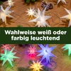 A string of star-shaped LED lights, shown in both warm white and colorful settings, with pine branches and cones. Produktbild-Vorschau