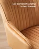 Close-up of a caramel brown upholstered chair, highlighting the velvet texture and stitching. Produktbild-Vorschau