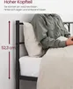 A person is sitting up in bed, leaning against a pillow, with the headboard of a bed visible. Produktbild-Vorschau