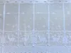 A white lace curtain with a Christmas theme, featuring deer and snowflakes. Produktbild-Vorschau
