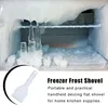 A close-up view of frost and icicles inside a freezer, with a small white shovel in the foreground and descriptive text. Produktbild-Vorschau