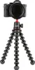 A black camera is mounted on a flexible tripod. Produktbild-Vorschau