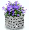 A potted plant with purple flowers in a silver pot. Produktbild-Vorschau
