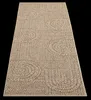 A rug with a patterned texture is shown from a diagonal angle against a black background. Produktbild-Vorschau
