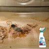 A dirty oven interior with a bottle of oven cleaner in the foreground. Podgląd zdjęcia produktu