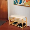 A shoe rack with a bench in an entryway next to a door. Produktbild-Vorschau