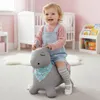 A baby girl is happily riding a gray inflatable pony in a nursery. Anteprima dell’immagine prodotto