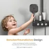 A child reaching for a shower head in a bathroom. Anteprima dell’immagine prodotto
