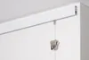 A close-up view of a white picture rail system mounted on a wall, with a perlon cord and a silver clip hanging from it. Náhľad obrázku produktu