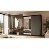 A bedroom scene featuring a sliding door wardrobe, a dressing table with a mirror, and a chair. Produktbild-Vorschau