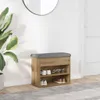 A shoe bench with storage shelves in a hallway next to a plant and a door. Voir les images du produit