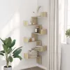 A corner shelf unit with various decorative items and books, placed next to a window with curtains and a potted plant. Náhľad obrázku produktu