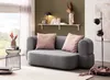A modern living room setting with a gray sofa, pink cushions, and decorative items. Produktbild-Vorschau