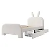 A white upholstered twin bed with a headboard shaped like bunny ears, shown from a side angle with two storage drawers pulled out. Anteprima dell’immagine prodotto