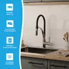 A kitchen sink with a faucet, set against a tiled backsplash and cabinetry. Produktbild-Vorschau
