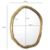 A gold-colored, irregularly shaped mirror with dimensions indicated by text overlays. Podgląd zdjęcia produktu
