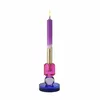 A single candle holder with a lit candle. Anteprima dell’immagine prodotto