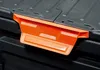 Close-up of an orange handle on a black plastic container. Náhled obrázku produktu