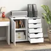 A white storage cabinet with drawers and a door, placed next to a desk with a lamp and a printer on top. Anteprima dell’immagine prodotto
