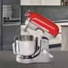 A red and silver stand mixer is shown in a kitchen setting. Podgląd zdjęcia produktu