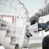 A person is using an angle grinder to work on a metal railing. Produktbild-Vorschau