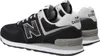 A pair of black New Balance sneakers shown from a side-rear angle on a white background. Voir les images du produit