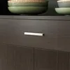 A close-up view of a dark gray cabinet drawer with a silver handle. Náhled obrázku produktu