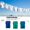 A clothesline with white shirts hanging in the background and colored t-shirts hanging in the foreground, with a city skyline in the distance. Náhľad obrázku produktu