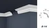 A white crown molding profile is installed in the corner of a room where the ceiling meets the wall. Produktbild-Vorschau