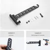 The image shows a black foldable wall-mounted clothes rack and its installation instructions. The top part displays the product and its accessories, while the bottom part shows two installation methods: 'Installation A: No Drilling' and 'Installation B: Dr Produktbild-Vorschau