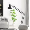 A modern living room scene with a floor lamp, sofa, and pouf. Anteprima dell’immagine prodotto