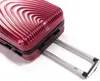 A close-up shot of a red suitcase with its telescopic handle extended. Náhled obrázku produktu