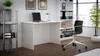 A modern home office setup with a white desk, black chair, and a bookshelf filled with binders and decorative items. Náhľad obrázku produktu