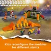 A LEGO City Stunt Park playset with ramps, obstacles, a motorcycle, and minifigures, set in an arena with spectators in the background. Podgląd zdjęcia produktu