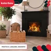 A cozy living room scene featuring a fireplace with a burning fire, a wicker basket filled with firewood, and decorative plants. Náhľad obrázku produktu