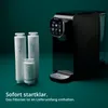 A black water purifier with three white filter cartridges in front of it, set against a dark teal background. Produktbild-Vorschau