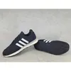 A pair of black Adidas running shoes with white stripes, shown from a side and bottom view, against a textured gray background. Produktbild-Vorschau