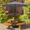 A wooden picnic table with a gray umbrella in a garden setting. Produktbild-Vorschau