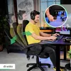 A man is playing a video game while sitting in a gaming chair. The chair is shown in different reclining positions. Produktbild-Vorschau