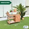 A wooden serving trolley with a stainless steel top, set up on artificial grass, with plants in the background. Produktbild-Vorschau
