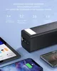 A black power bank is shown with several electronic devices, including a tablet and smartphones, suggesting its use for charging them. Produktbild-Vorschau