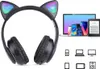 A pair of black cat-ear headphones with LED lights, shown next to a collection of electronic devices and icons representing various compatible devices. Náhled obrázku produktu