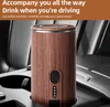 A portable coffee maker sits in a car's cup holder. Produktbild-Vorschau
