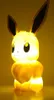 A lit-up, yellow LED lamp shaped like the Pokémon character Eevee against a yellow background. Náhľad obrázku produktu